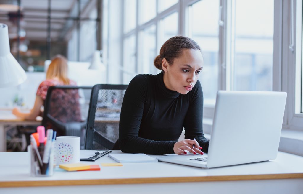 Woman working on a laptop at a desk